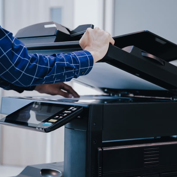 person using scanner to scan paper documents