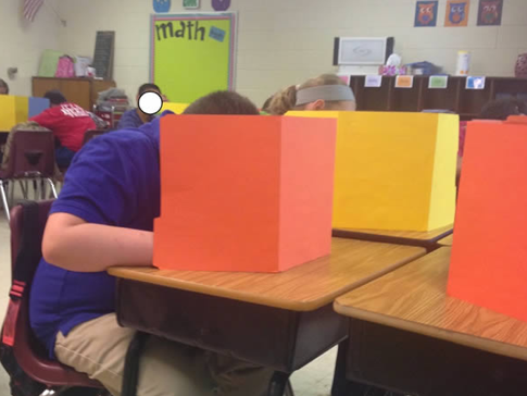 man hiding behind folders